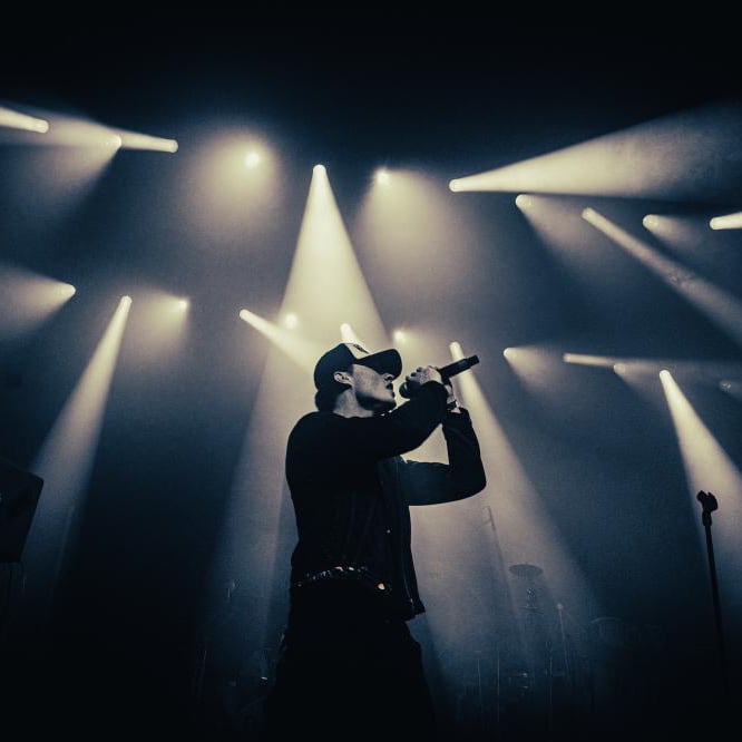 Asger performing on stage under concert lights