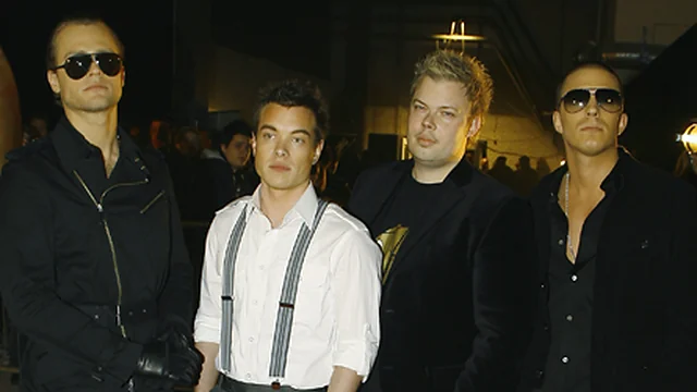 Jules Wolfson with Jon, Nik and Jay at an event in 2006