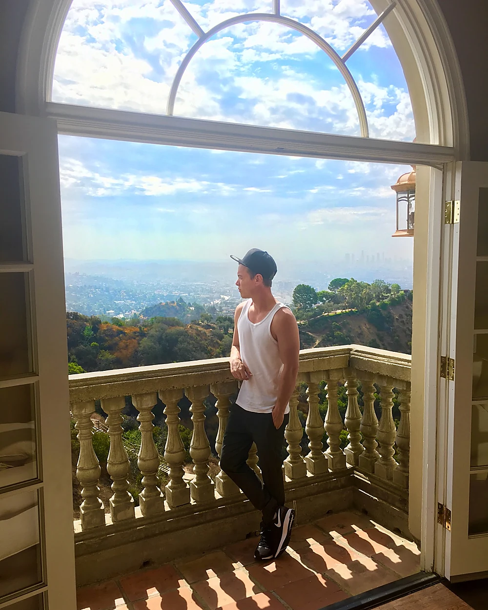Jules Wolfson on a balcony overlooking the city